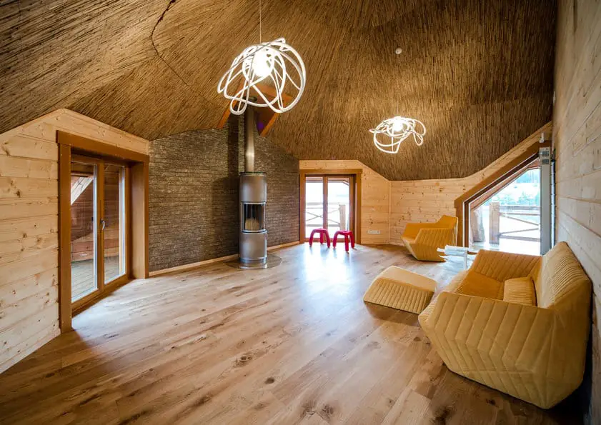 fashionable-living-room-with-wooden-floor-and-walls-and-straw-ce