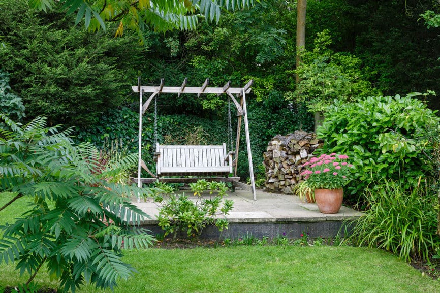 Back garden and patio with furniture in a British home