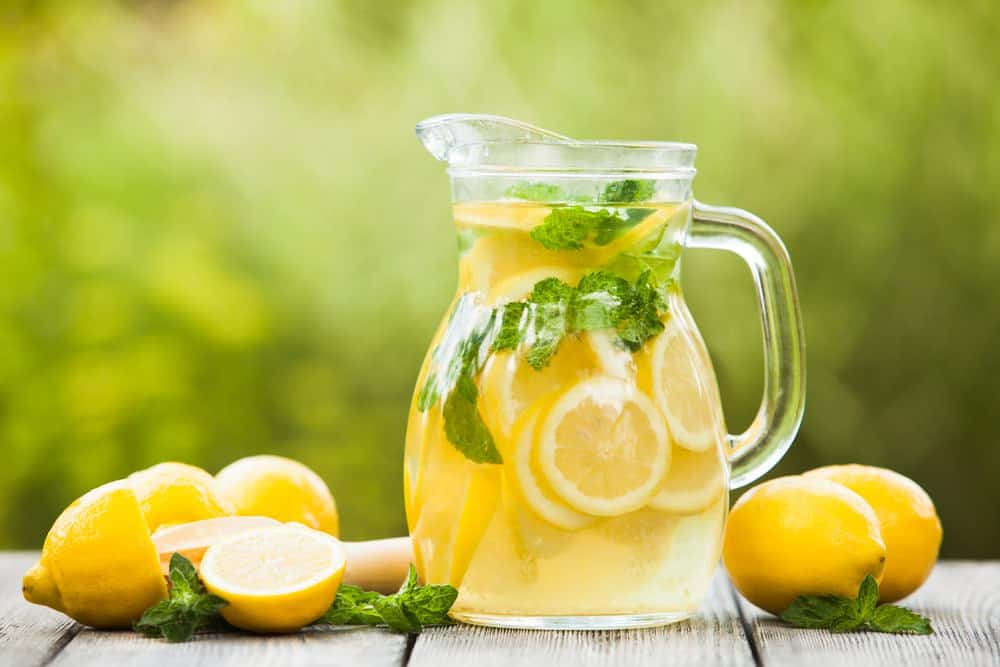 pitcher of lemonade with fresh lemons