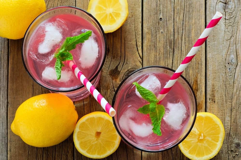 glass of pink lemomade made from a powdered mix