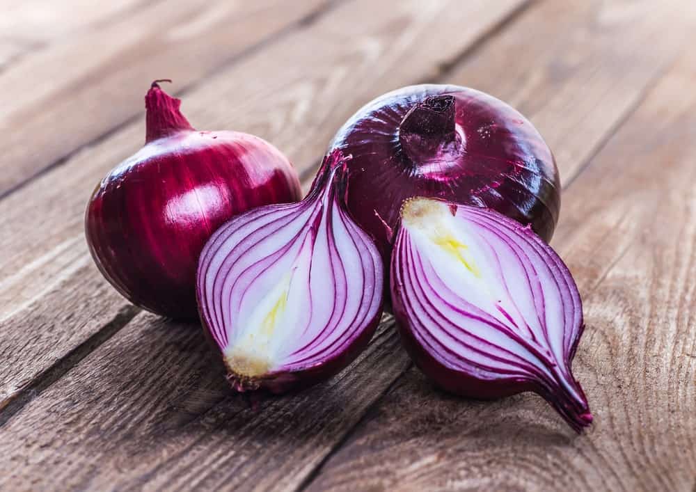 red onions on a rustic wood