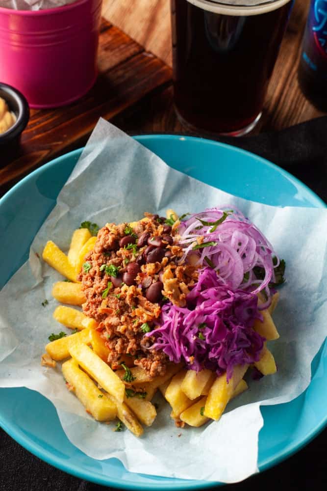 Super nutritious carne asada hot french fries with mexican-style salsa minced meat, red beans, red onion and coleslaw as a perfect beer snack