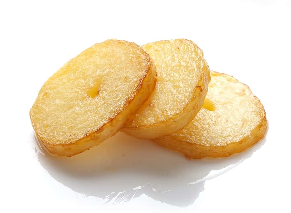 Three isolated fried pieces of potato on the white background.