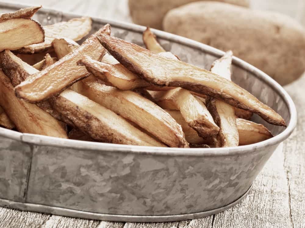 close up of rustic natural cut home french fries.