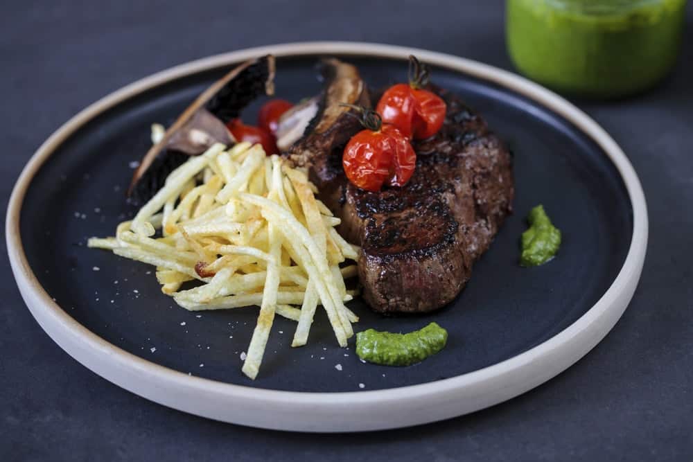 Fillet steak with roast tomatoes, matchstick fries and salsa verde.