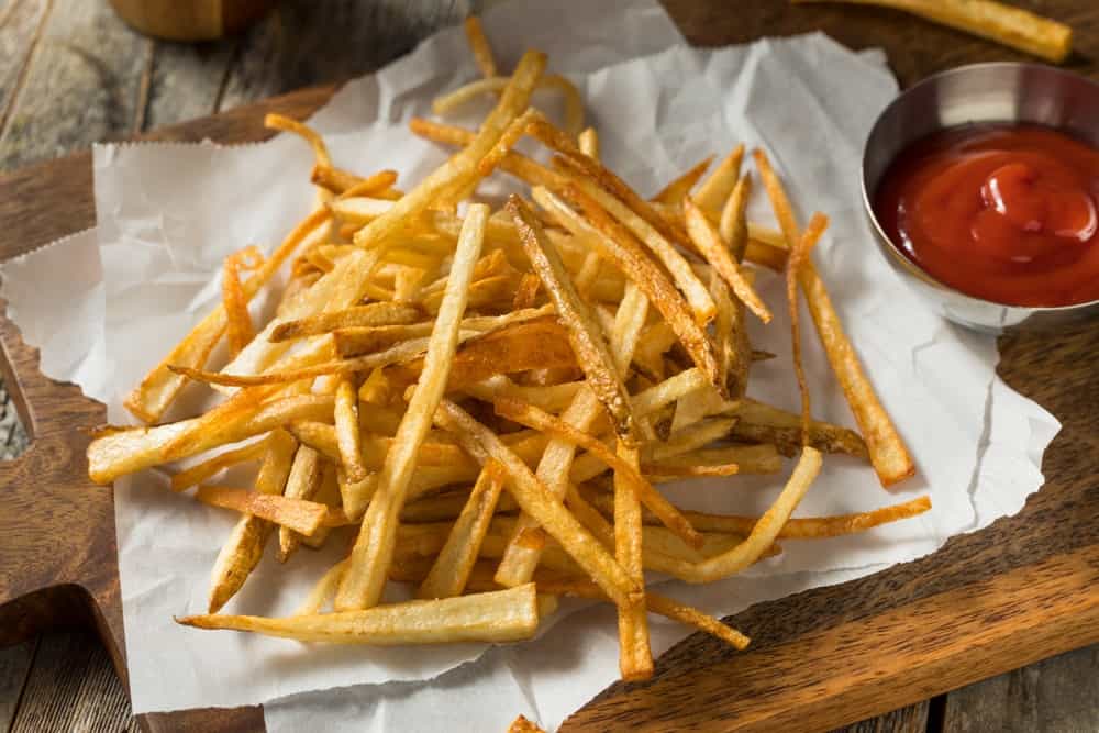 Homemade shoestring fries with ketchup on the side.
