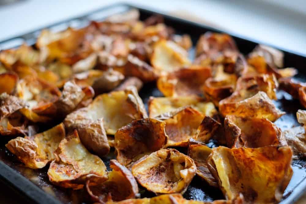 Baked potato skin crisps on a tray.