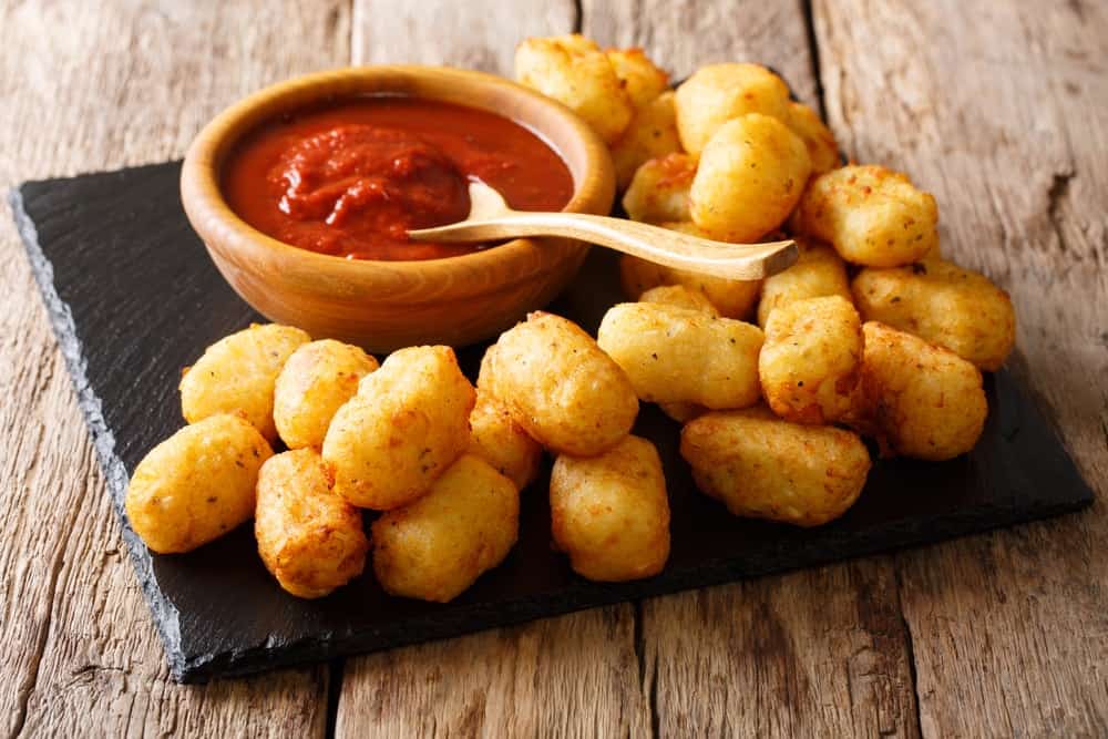 Organic Fried Tater Tots made from fried potato and ketchup close-up on the table.