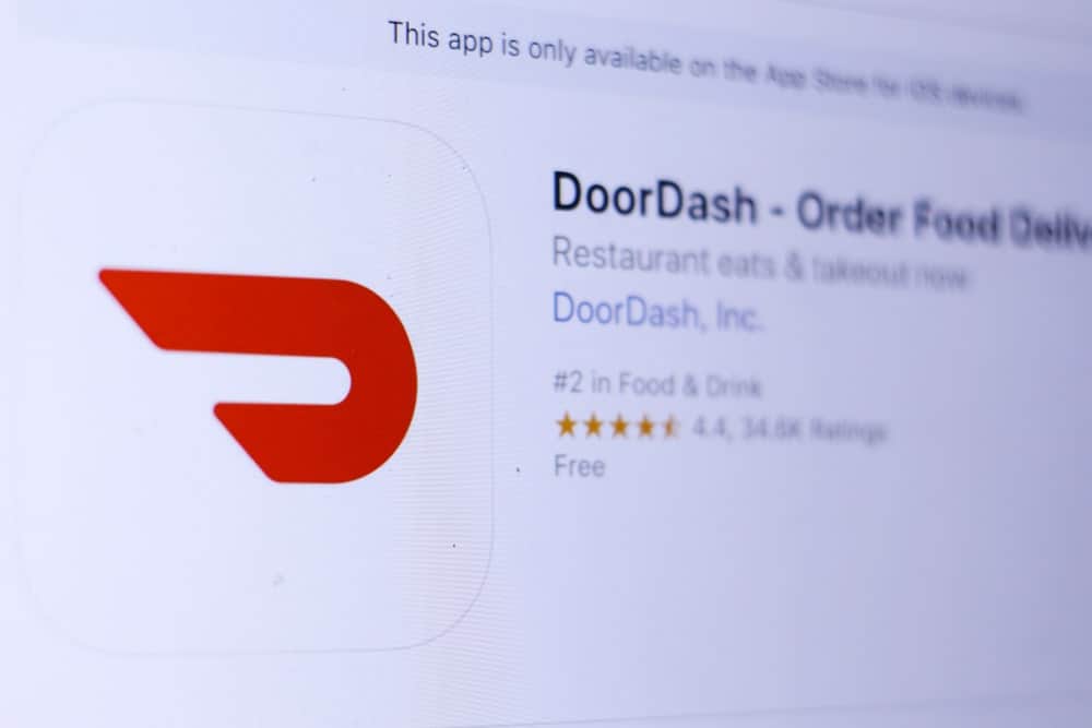 DoorDash logo and homepage on a digital screen.