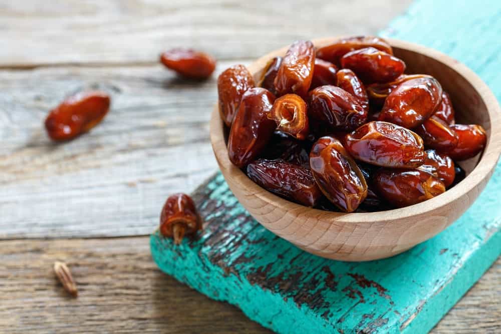 A wooden bowl of beautiful mouth-watering Dried Dates.