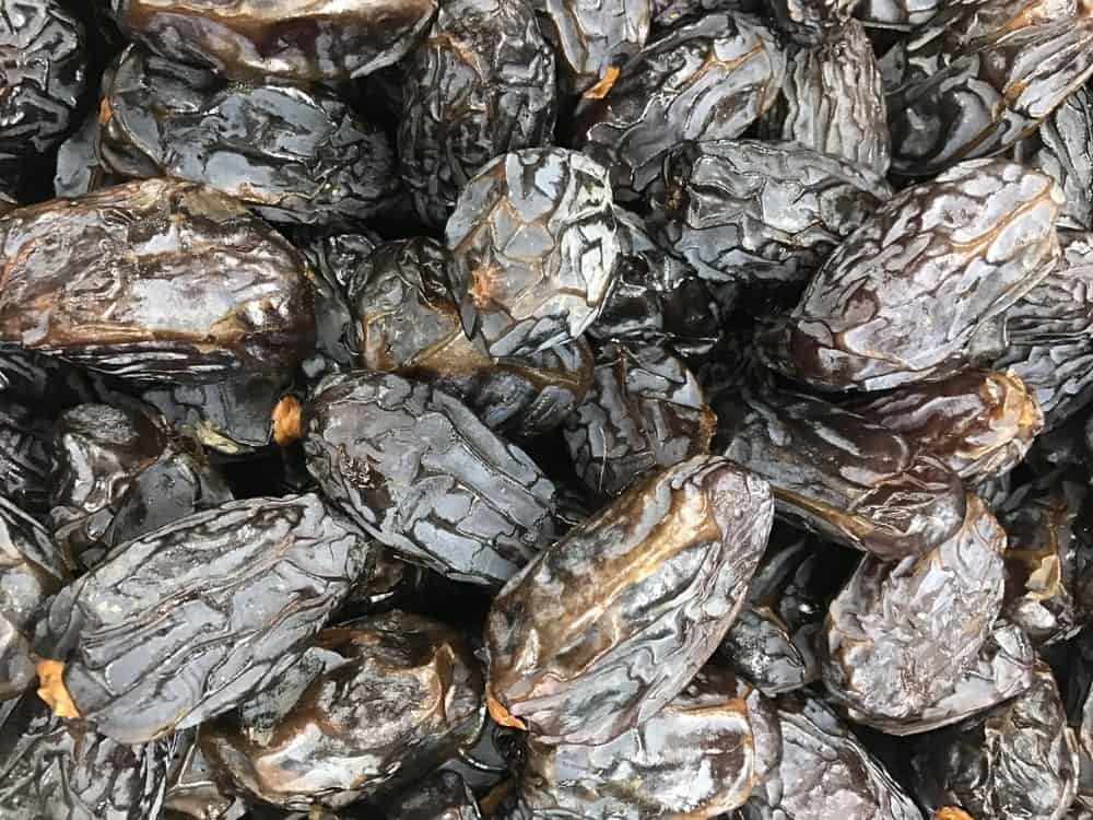 A bunch of yummy Khudri Dates with its dark brown and wrinkled skin.