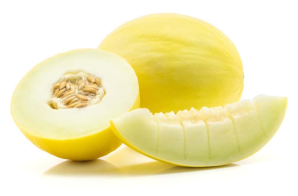 Bailan Melon and one half with a slice cut into pieces isolated on white background.