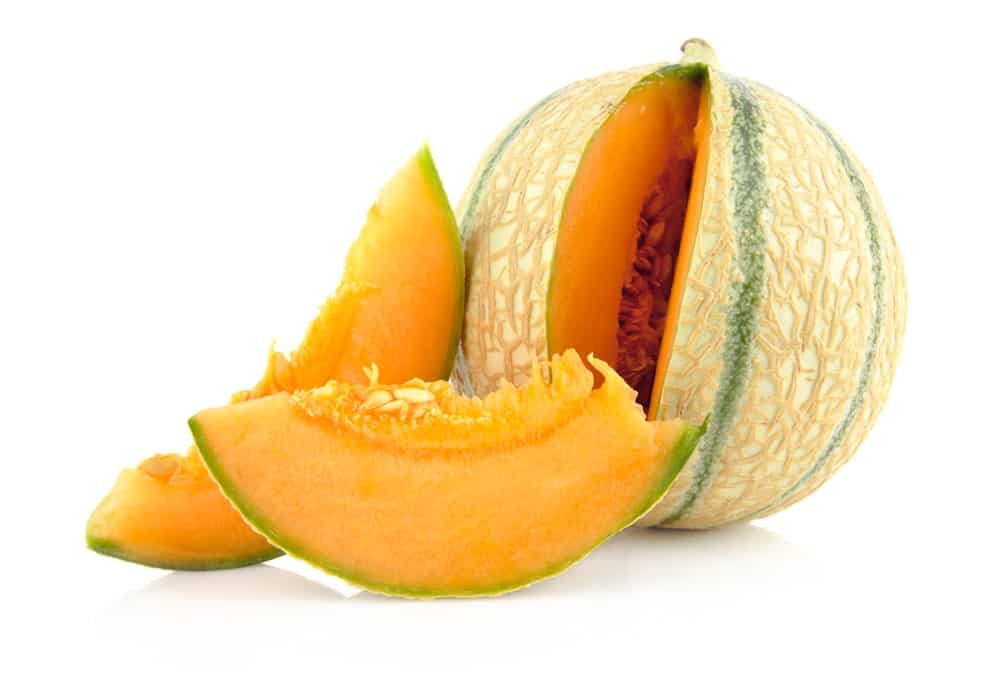 A sliced piece of Charentais Melon with a bright orange flesh.