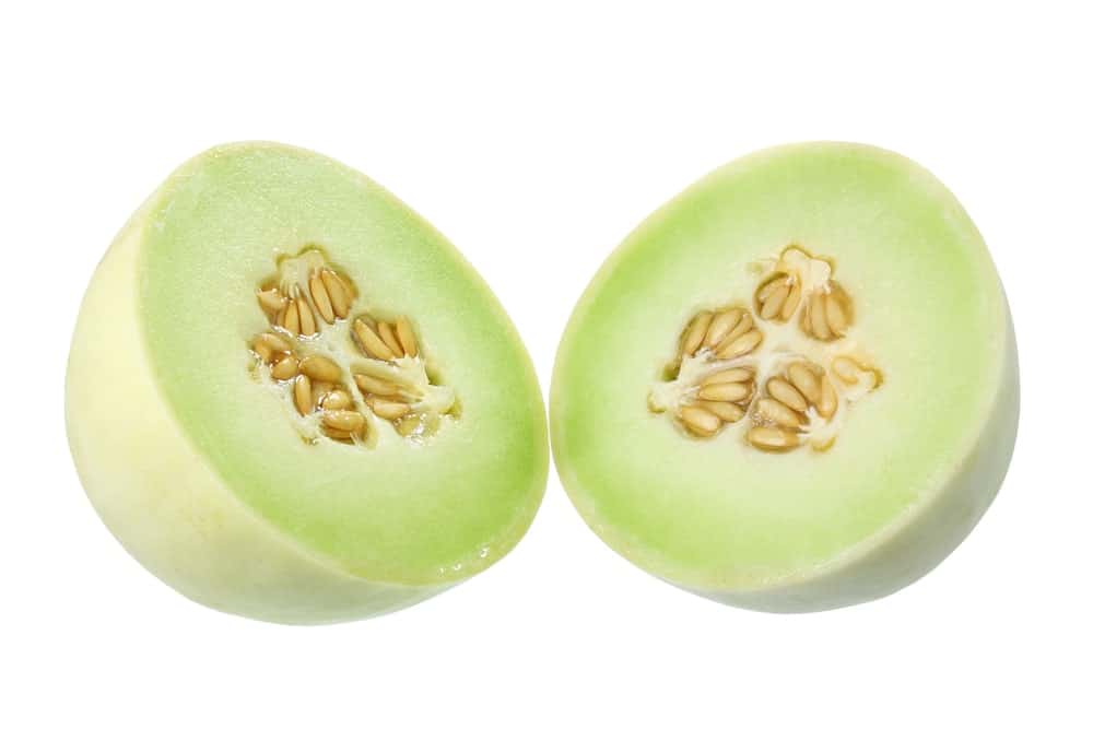 A Honeydew Melon cut in half to reveal its juicy insides.