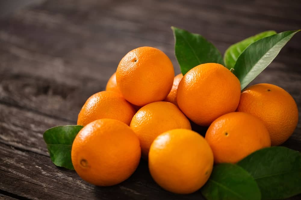 Oranges on a wooden background.
