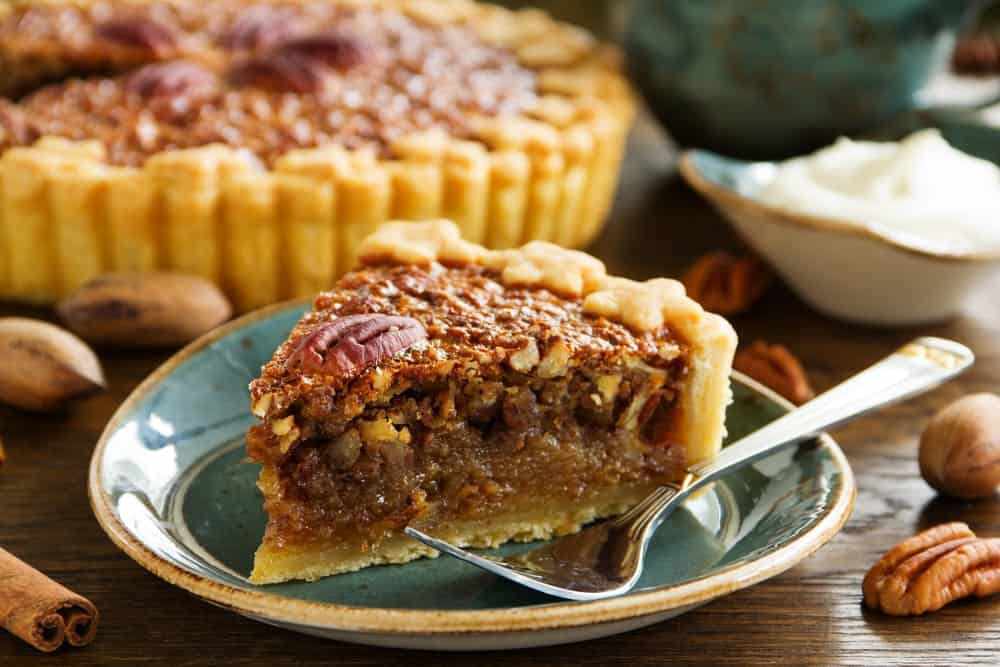 A slice of pie with a fork on a desert plate.