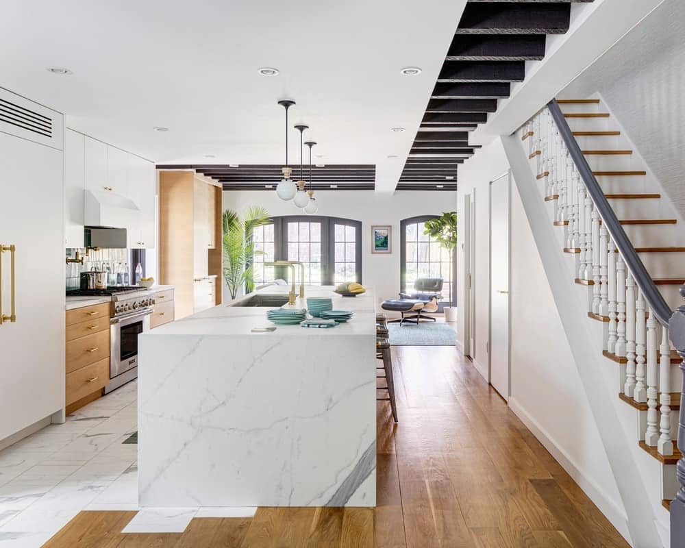 Keep it fresh and calm with a nautical style, complete with orange and teal accents, pendant lighting, and a combination of wood and marble design flooring.