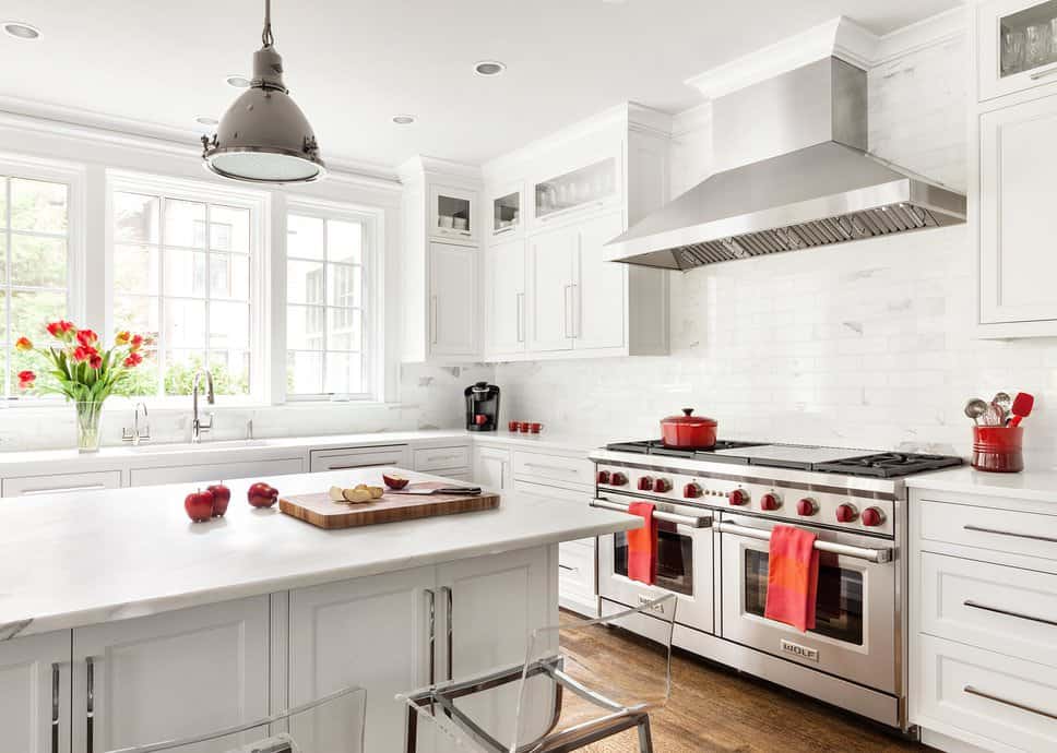 For an Asian kitchen, this one has a simple white and red color scheme. The entire kitchen looks wide and spacious especially with its all-white interiors, with the exception of the red accent on the stove switch, towels, cooking pans, and coffee mugs. The steel appliances such as the range hood and the double door oven also go well with the interiors. For some natural light, this kitchen has glass windows by the sink.