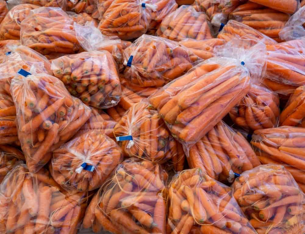 Bags of fresh cleaned Toushon Carrots for sale.