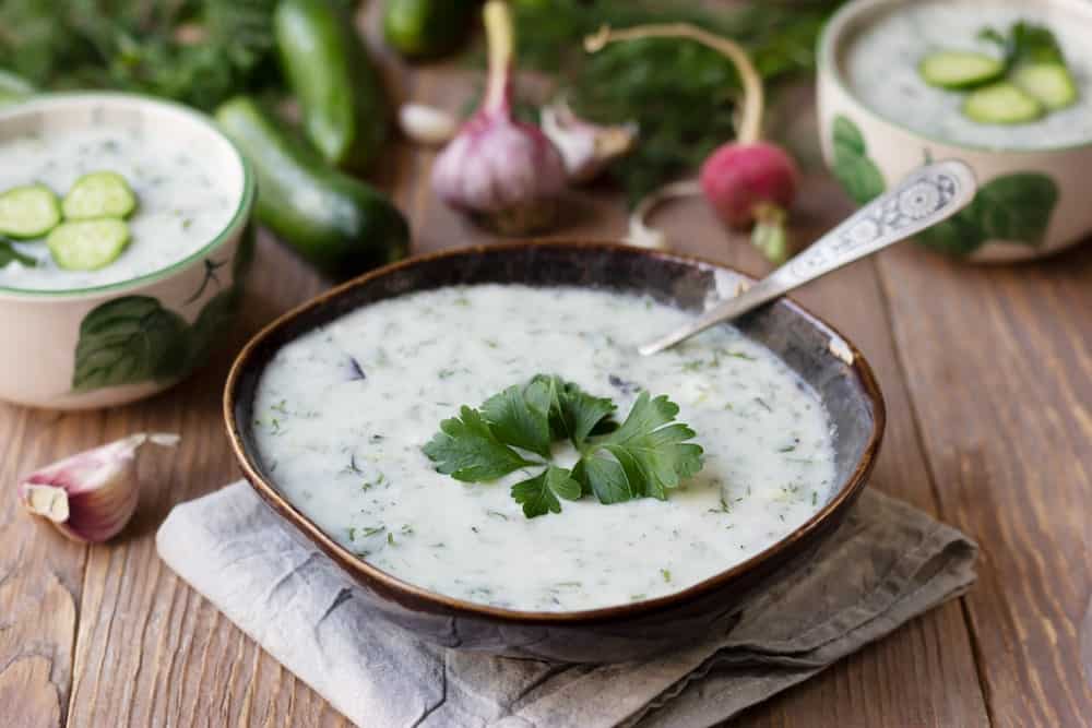 A fresh bowl of homemade matsoni yogurt flavored with cucumber and herbs.