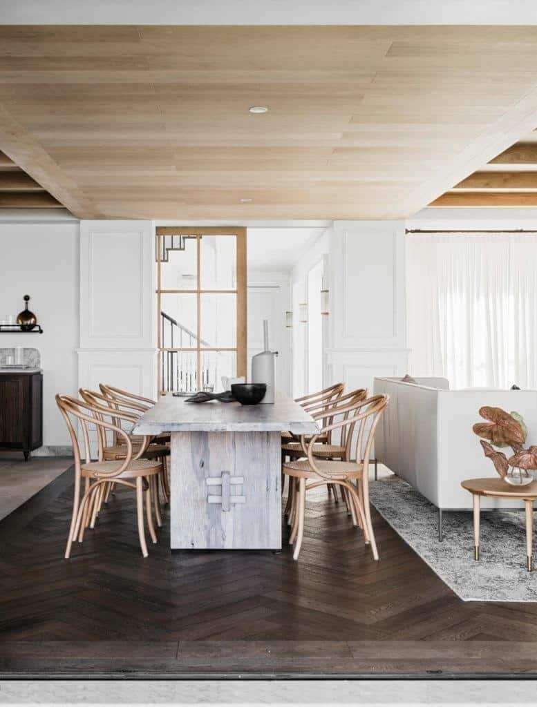 A dining area featuring hardwood flooring and a classy table along with stylish chairs.