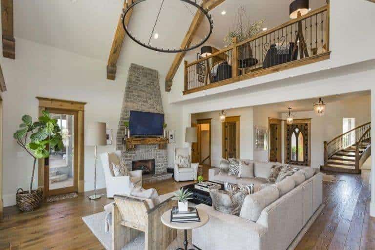 Elegant living space looks perfect together with this stylish hardwood flooring and the cozy sofa is just perfect together with the stylish fireplace.
