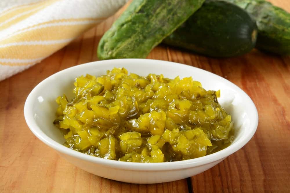 A delicious bowl of pickle relish on a wooden surface.