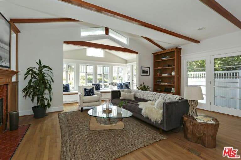 Contemporary living space with a stylish couch and glass table. This room features white walls with glasses.
