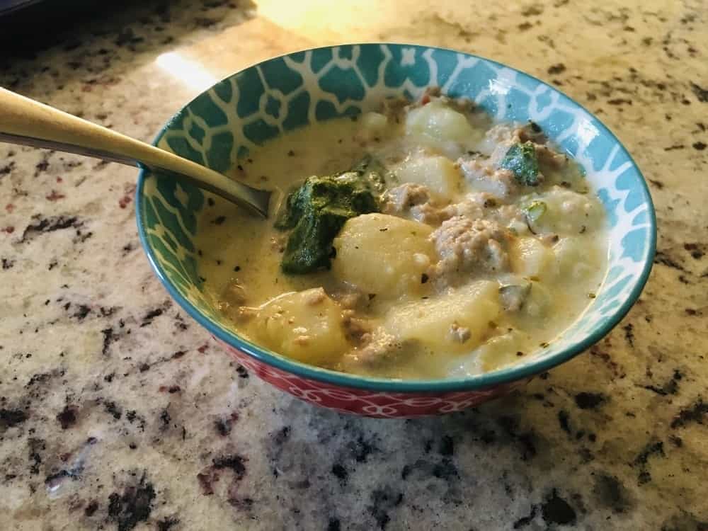 A delicious bowl of creamy spinach and Italian sausage soup.