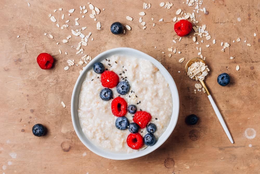 A bowl of oatmeal with berries.