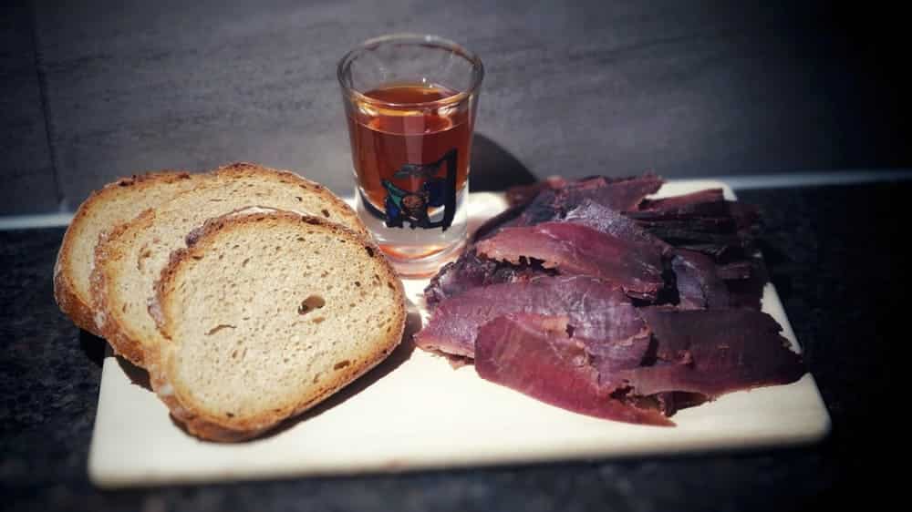 Slices of bacon made from venison with pieces of bread.