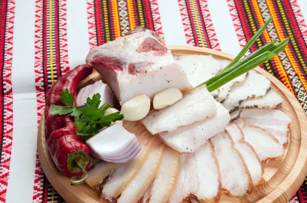 A close look at a spread of traditional Ukrainian salo on a chopping board.