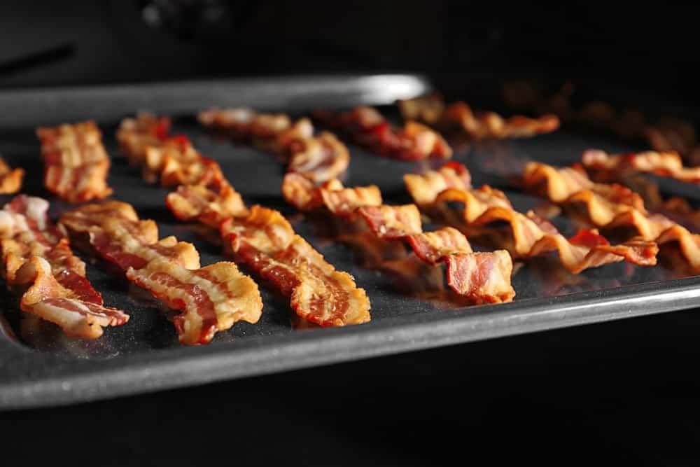 Pieces of crispy bacon baked in the oven.