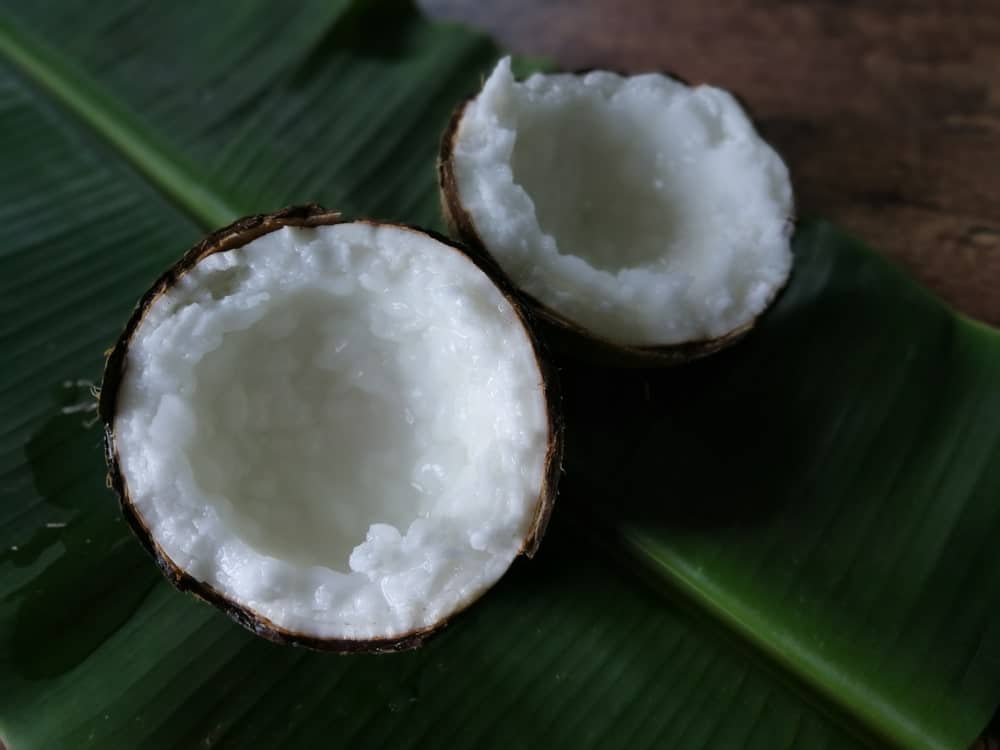 A close look at a macapuno coconut fruit cut in half.