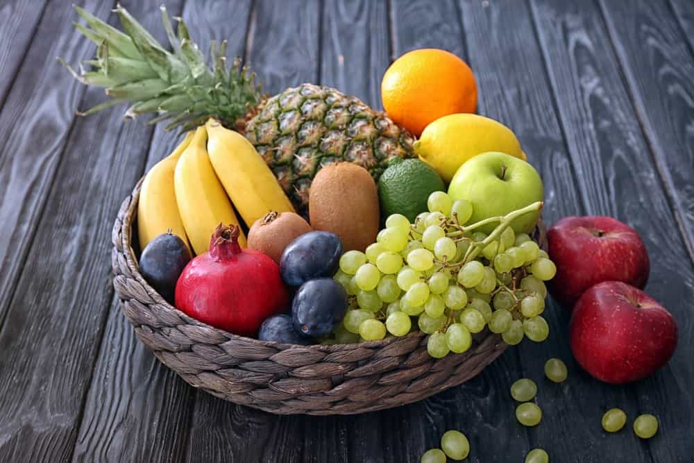 A rustic basket filled with different fruits.