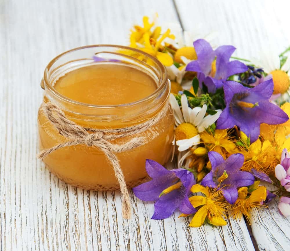 A glass jar of wildflower honey.