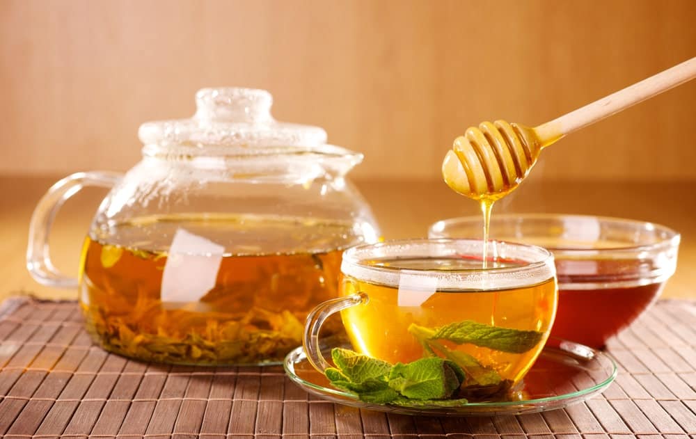 A close look at tea being prepared with honey.