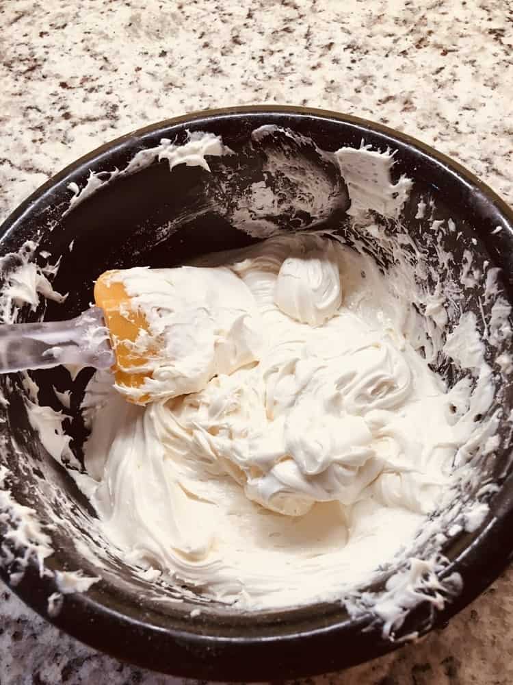 The icing is mixed in a bowl until fluffy.