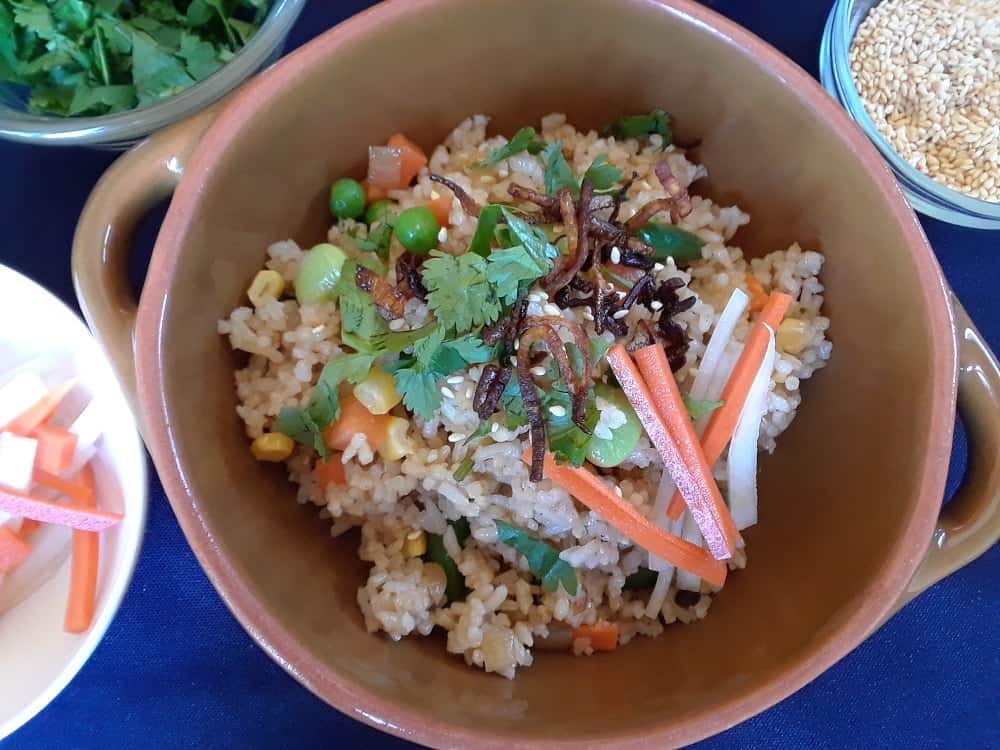 A bowl of freshly cooked vegan fried rice with complete toppings.