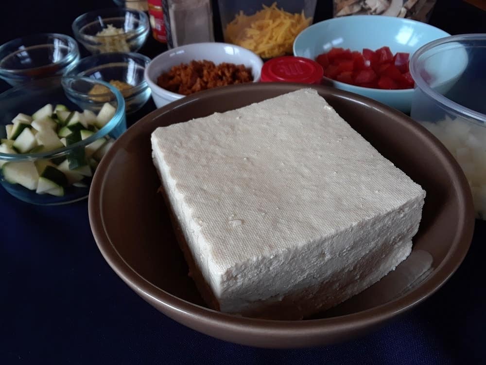 A block of tofu to be used in the recipe.