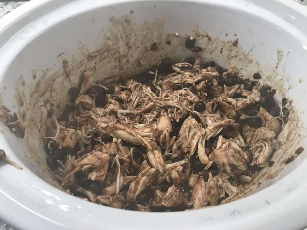 The chicken is then shredded in the slow cooker.