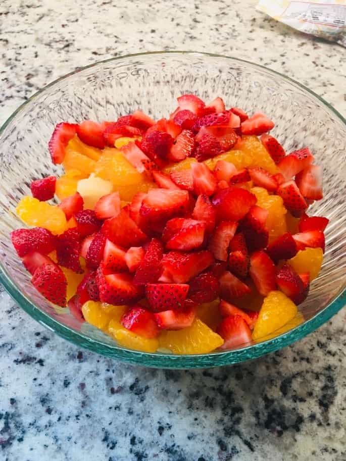 The fruit slices are placed in a large bowl.