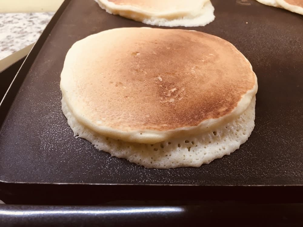 The pancakes are flipped to cook the other side.