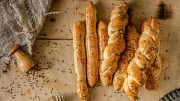 A bunch of freshly-baked garlic and herb bread sticks.