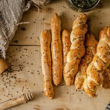 A bunch of freshly-baked garlic and herb bread sticks.