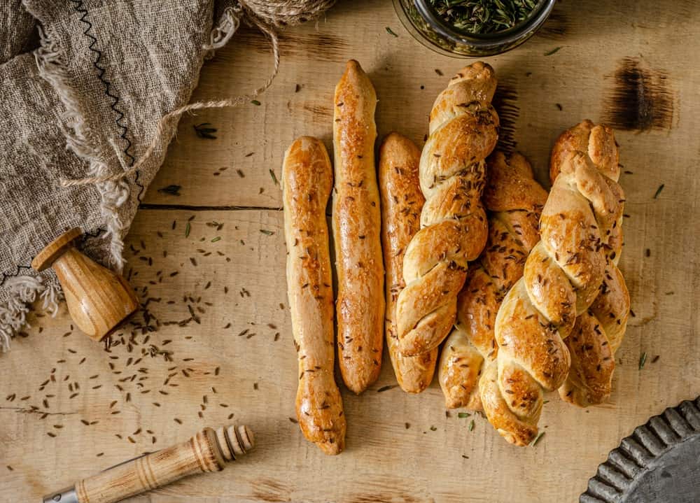 A bunch of freshly-baked garlic and herb bread sticks.