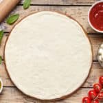 A freshly-made homemade pizza dough ready to be assembled with toppings.