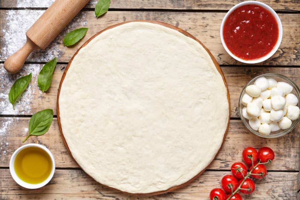 A freshly-made homemade pizza dough ready to be assembled with toppings.