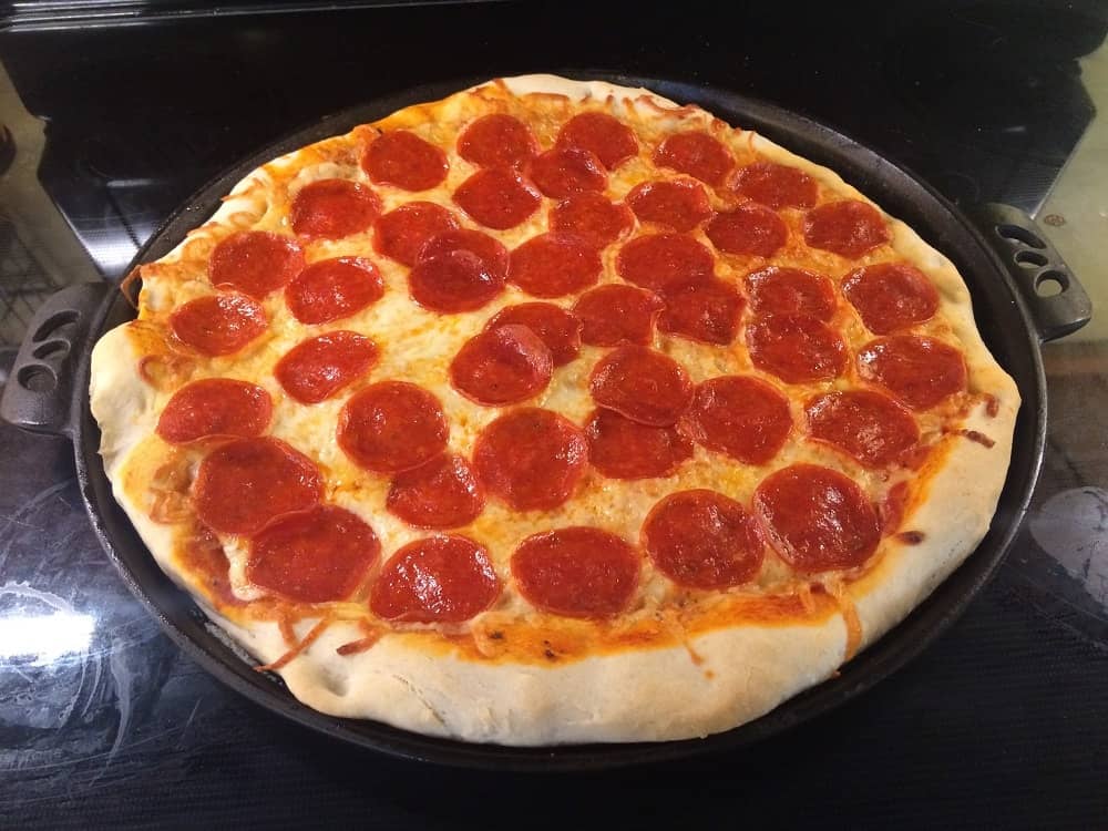 A freshly-baked homemade pizza with pepperoni toppings.