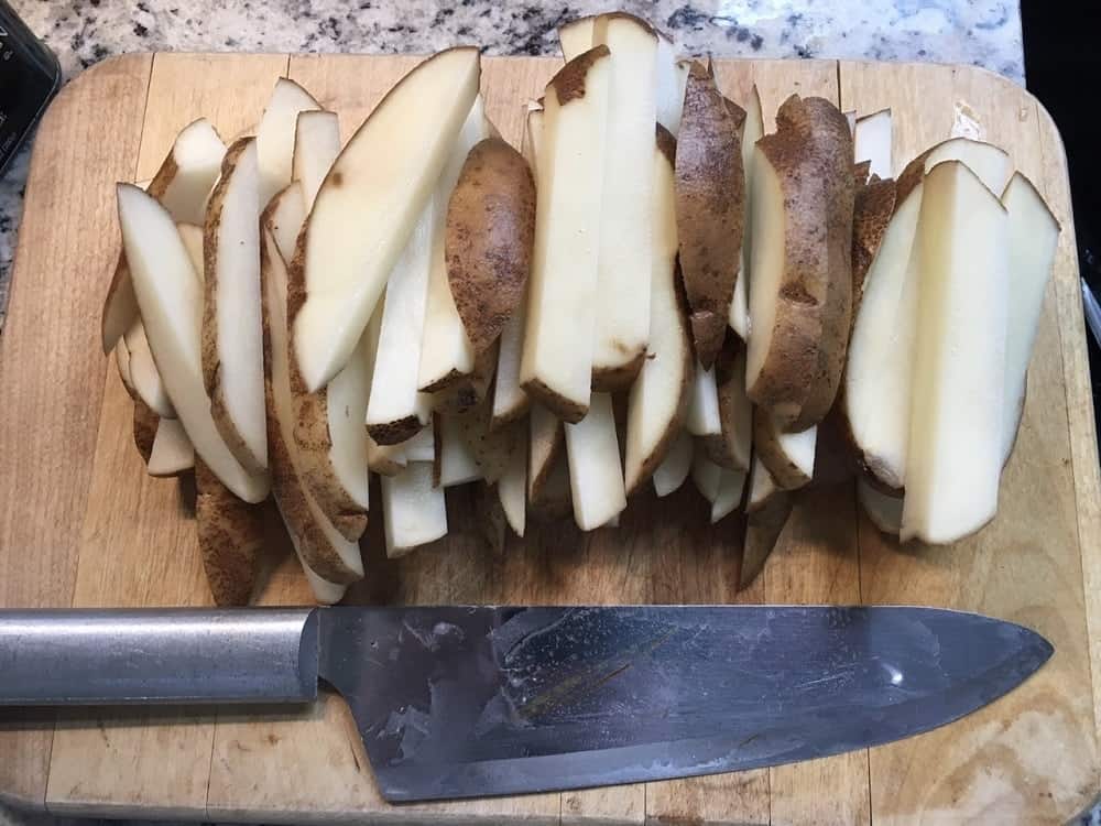 The potatoes are sliced into wedges.